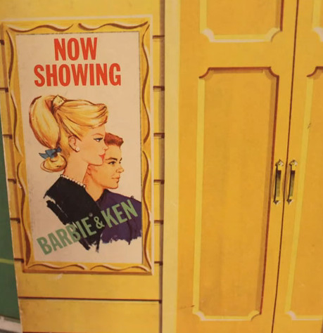 Detail from the image of the theatre exterior further up the page, focused on a poster that reads "NOW SHOWING/BARBIE & KEN." Barbie and Ken are shown in profile; it is unclear if or how they are costumed. Barbie has a blonde ponytail, pearl jewelry and a blue ribbon tied near the bottom of her ponytail.
