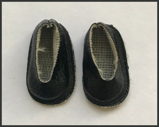 a pair of black leather-look slippers (?) roughly in the shape of plastic bags taped over your shoes