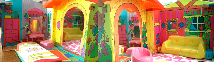 Same interior as immediately above, but two shots with the camera aimed slightly toward the center of the house from either side. Between the rooms is a yellow wood-look wall with large arched doorframe. To one side of the door is a yellow oval frame with pink interior, and to the other is a potted plant covered in colorful balls. The wall screening seems identical from either side, in other words, the two rooms have the same decor on the shared wall.
