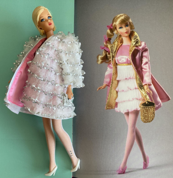 Carol Spencer's book lies open with sea green paper covering the left side. On the right side is a photograph of Talking Barbie wearing Pink Premiere: minidress with pink bodice, tiered, ruffled white skirt with pink trim, and gold waistline, pink sateen coat with gold trim, pink sheer hose, pink translucent shoes, and hold handbag. Lying on top of the other side is the Hair Fair Barbie reproduction wearing Hollywood Premiere: an oversized, tent-shaped jacket covered in white and silver ruffles with pink lining, silver envelope clutch, white sheer hose with rhinestone accent at the ankle, and white shoes. Her dress is not visible under the coat, but it's a short, metallic silver, ruched, figure hugging piece.