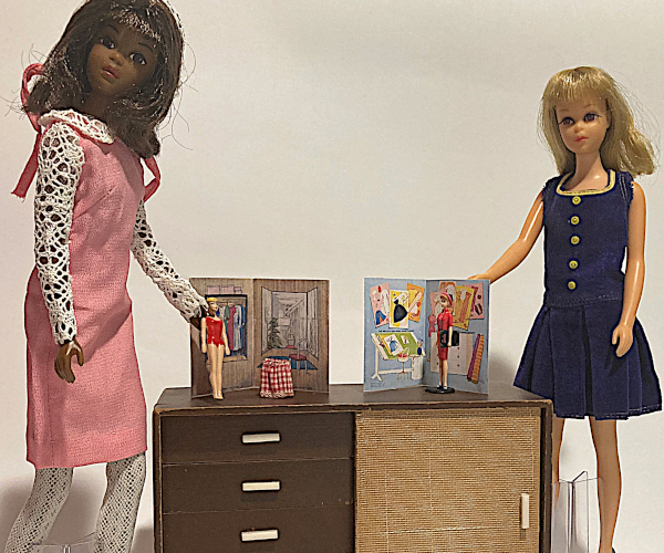 As described. The dressing room folder is wood-look with an illustrated rack of clothes, three-way mirror, and other items. The fashion designer's office includes an angled drafting table, a chest of shallow drawers, rolls of fabric, and sketches of Barbie garments lining the walls. The dolls and "folders" are positioned on top of the Mattel Modern sideboard and a Francie doll stands to either side.