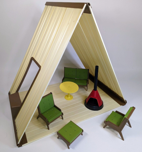Close up of the A-frame and its furniture, this time with no doll. This shot includes a circular yellow table in addition to the furniture pieces already described.