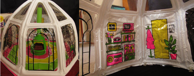 Views of the actual product form an old auction, here we can see the floor of the tent is a circular vinyl "rug" ringed in neon pink, yellow, and green. Screened on the back wall of the tent is matching decor: a built-in shelving system housing a monitor (black screen with white text that says "READ OUT: PRIMARY CIRCUITS"), a phone, a vase, some books, an 8-track or computer that reads and writes magnetic tape with a label that says "Audio Visual Control," A possible record player, and another computer-looking device with text reading "Auxiliary Bionic Computer Access." On a second wall is screened a potted rubber plant, a pink coat on a coat rack, a yellow closet door, and a black and white photograph of a man (maybe the six-million dollar man). 